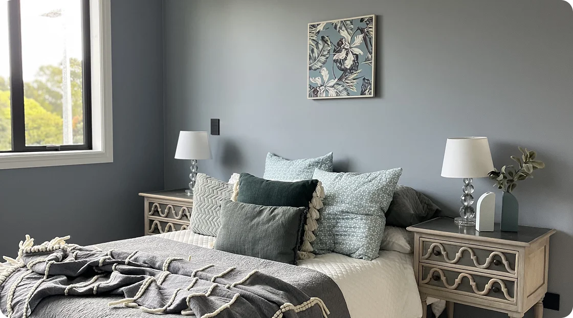 STAGY home staging Auckland: Master bedroom with grey bedding and bedside lamps.
