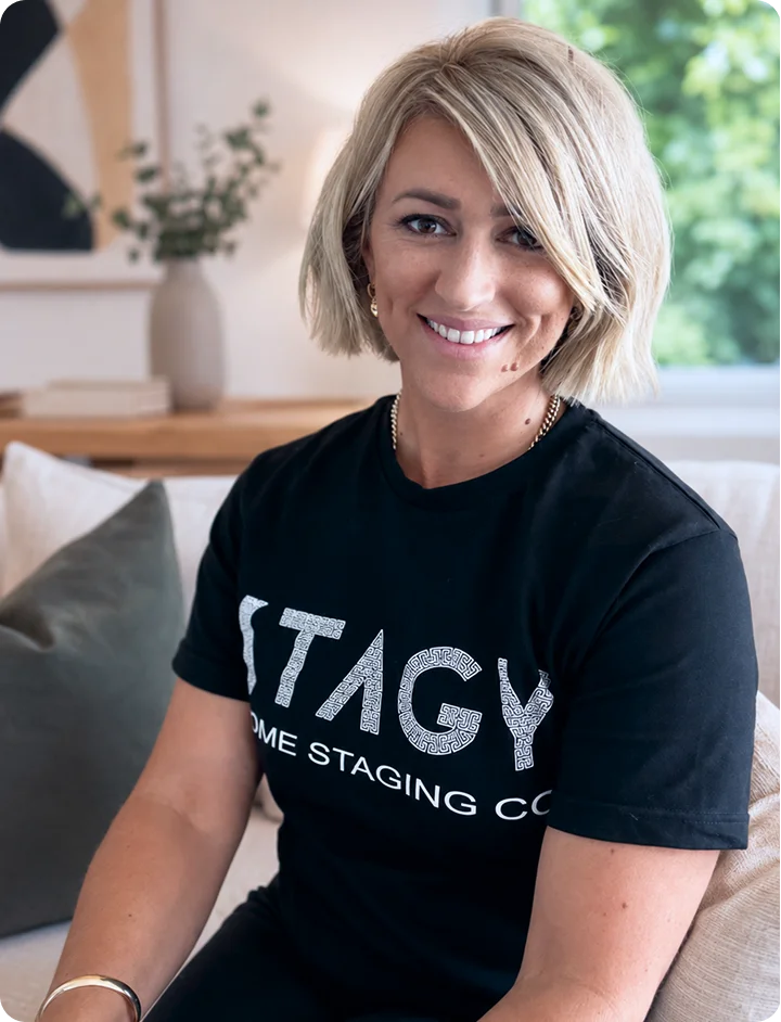 Smiling woman in a black t-shirt representing a home staging company, featured on the About page.