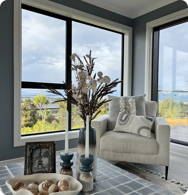 STAGY home staging Auckland: armchair, vase, and decor by window